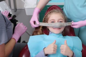 little girl receiving nitrous oxide at the dentist