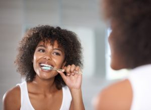 woman brushing her teeth